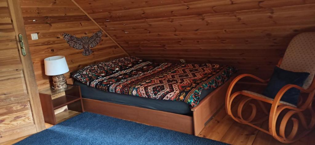 a bedroom with a bed in a log cabin at Dream Forest Cabin in Warsaw