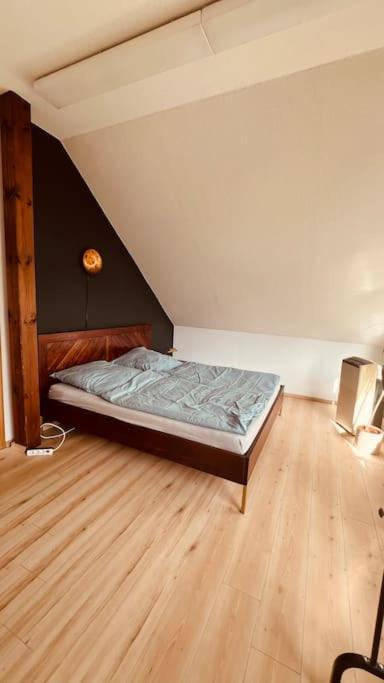 a bedroom with a bed in the corner of a room at Ferienhaus mit Seeblick in Templin