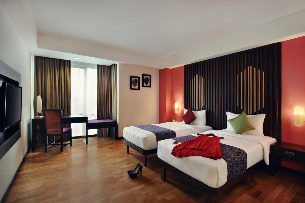 Postel nebo postele na pokoji v ubytování Mercure Pontianak City Center