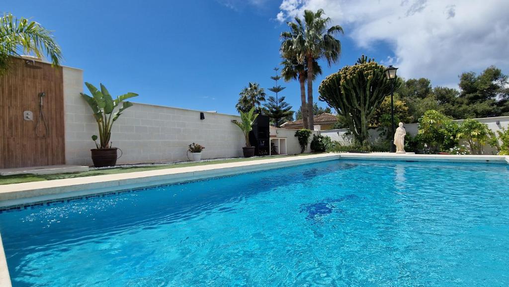 a swimming pool with blue water in a house at Villa Las Niñas Costa del Sol in Mijas