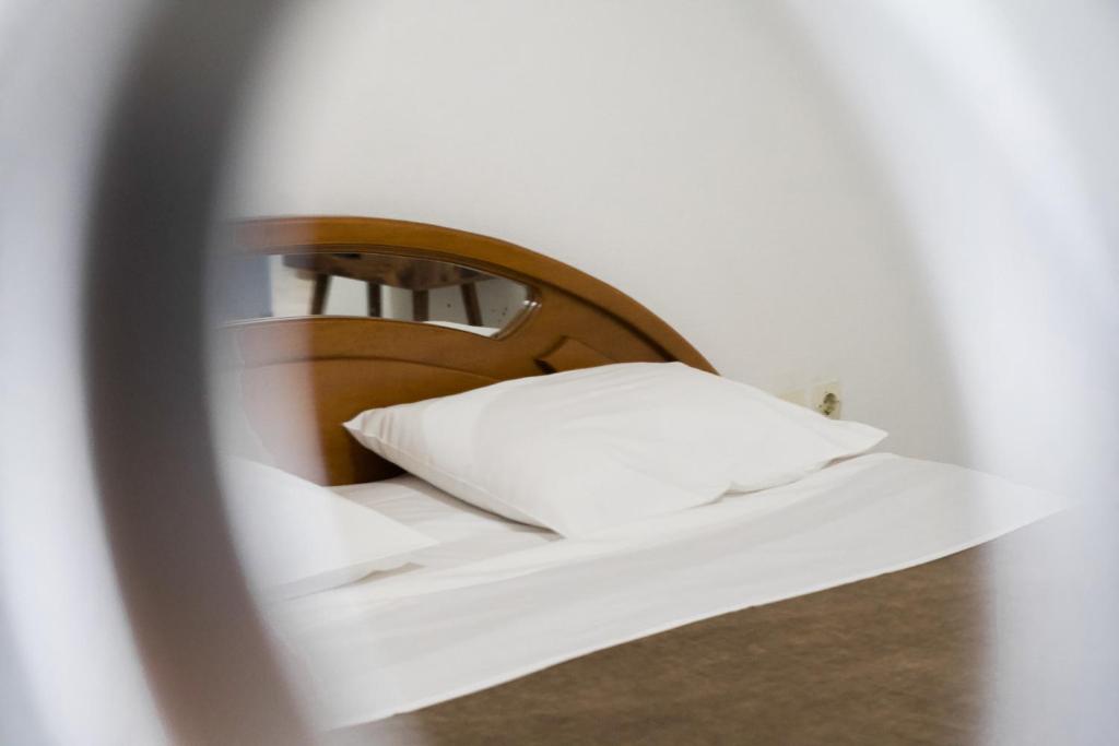 a bed with a white pillow in a room at Sea in Adelianos Kampos