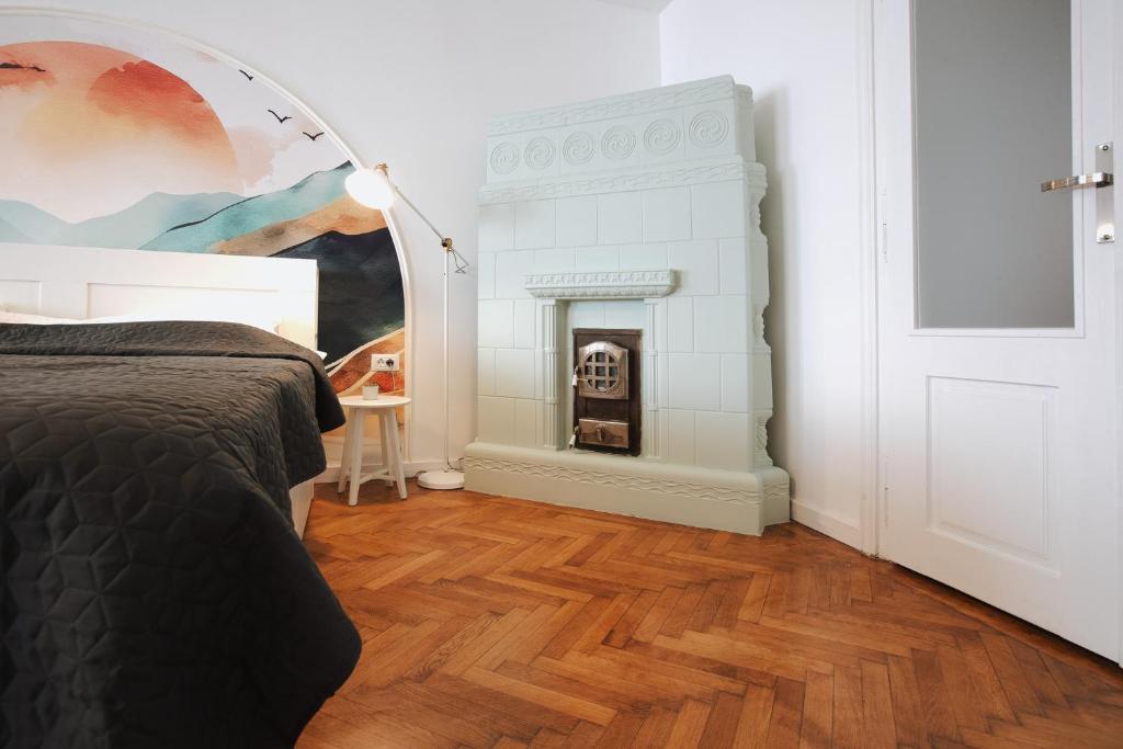 a bedroom with a bed and a fireplace at 3 min to everything-Stylish-Modern-Old Fortress in Braşov
