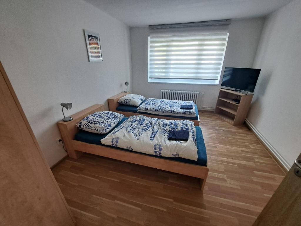 a bedroom with two beds and a television in it at Karolinka Radějov in Radějov