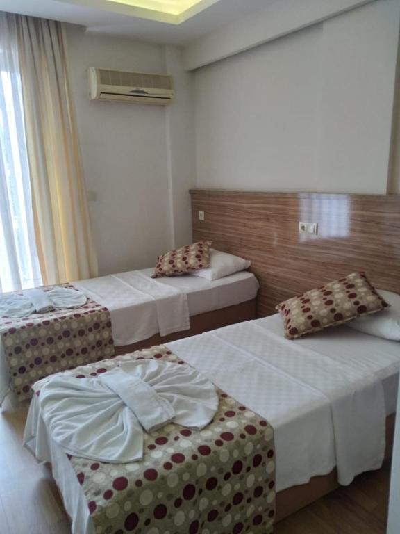 Postel nebo postele na pokoji v ubytování Hotel Barlas Fethiye