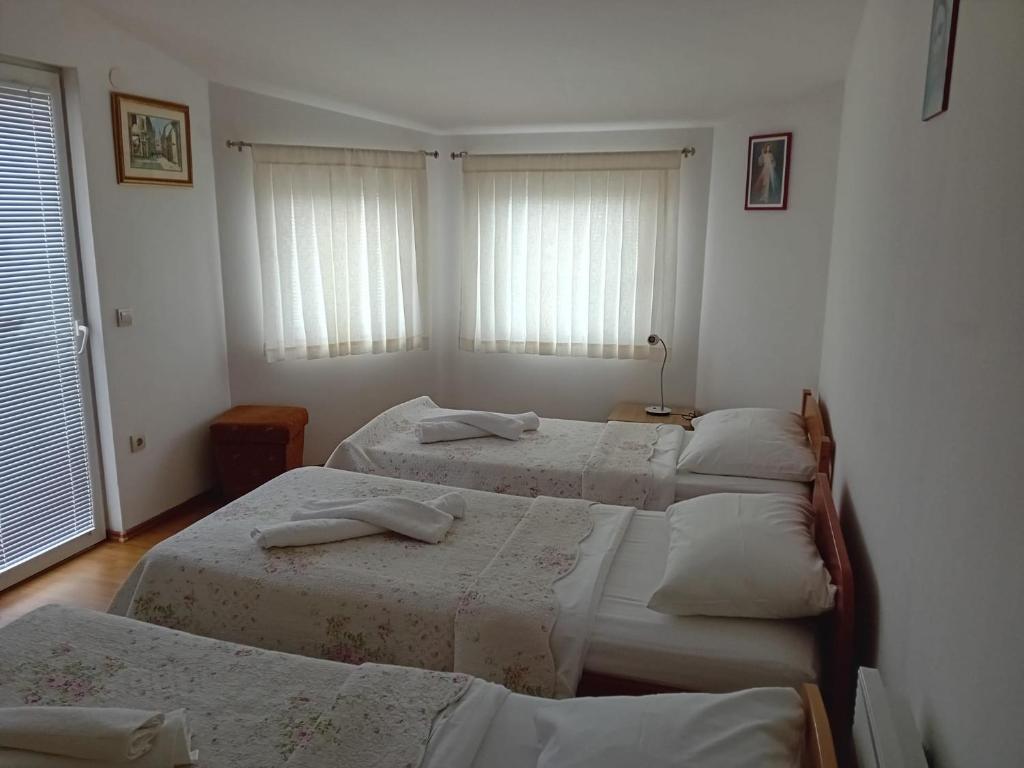 a bedroom with four beds in a room at Apartman Peace 3 in Međugorje