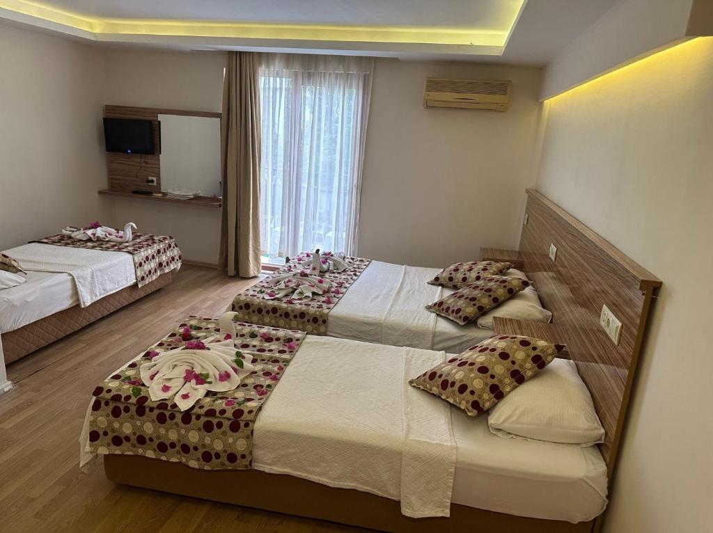 Postel nebo postele na pokoji v ubytování Hotel Barlas Fethiye