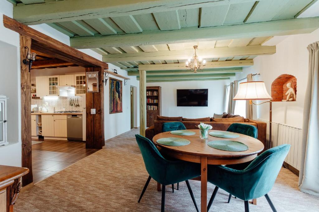 a dining room and living room with a table and chairs at Domček na Staromestskej. in Banská Štiavnica