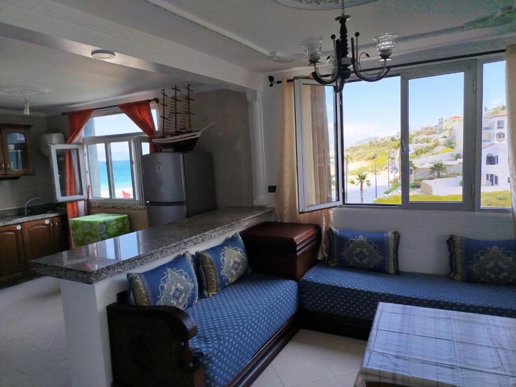 - une cuisine avec un canapé et une table dans une chambre dans l'établissement Apartment Corniche Ksar Sgher, à Ksar Sghir