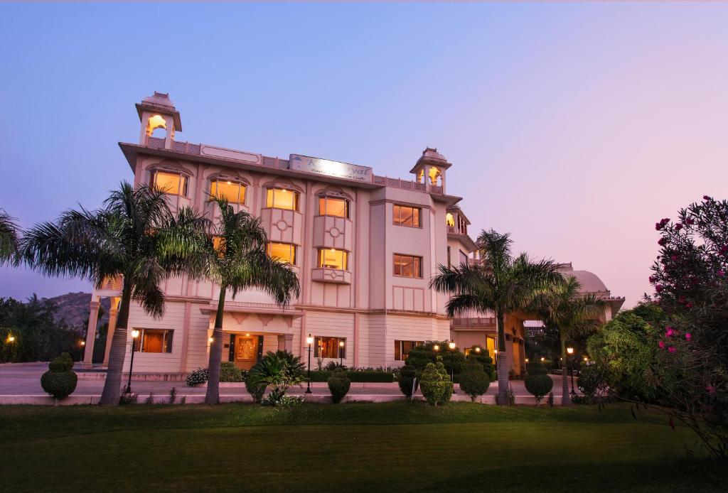 a large building with palm trees in front of it at KK Royal Hotel & Convention Centre in Jaipur