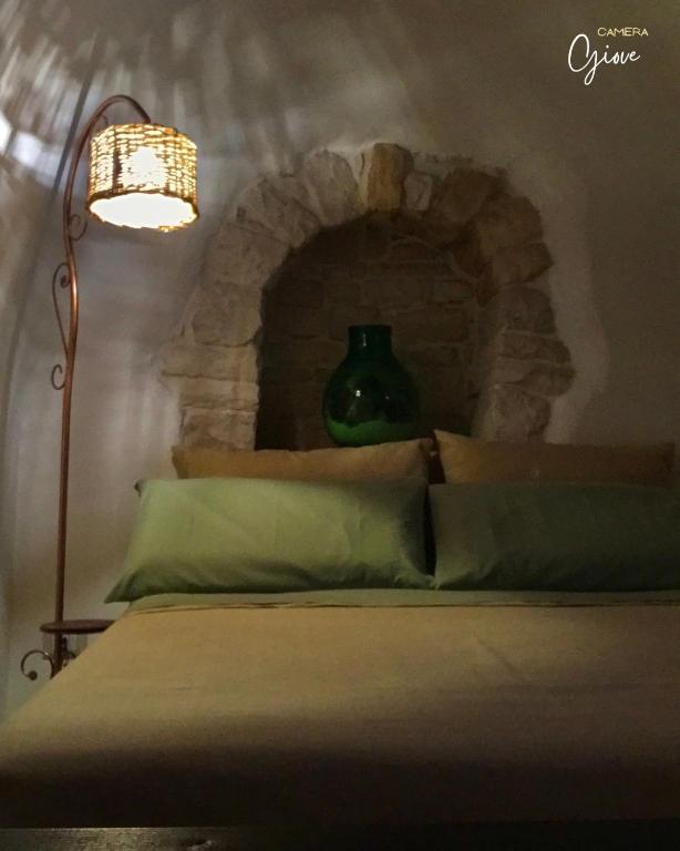 Postel nebo postele na pokoji v ubytování Trullo Galileo