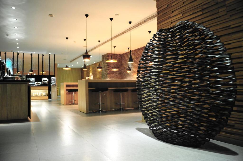 a large metal sculpture in a kitchen with a counter at The Riverside Hotel International in Kaohsiung