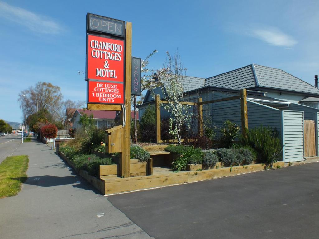 a sign for a garden center and a building at Cranford Cottages and Motel in Christchurch