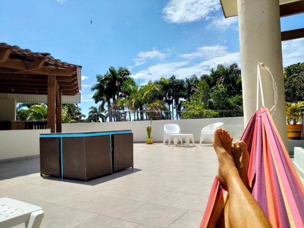 a person is laying in a hammock on a house at Okaina Studio Rooftop in Cabarete