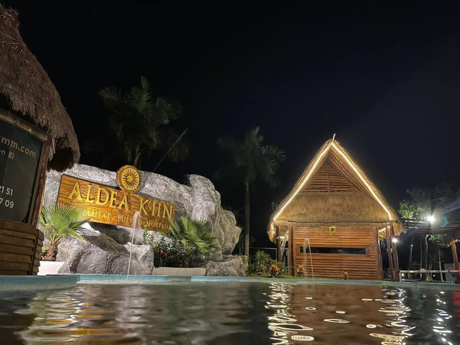 a resort with a swimming pool at night at Casa Maya in Puerto Morelos
