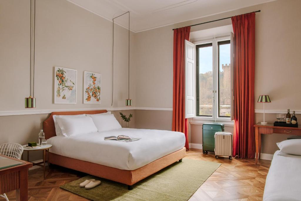a bedroom with a white bed and a window at The Sonetto powered by Sonder in Florence