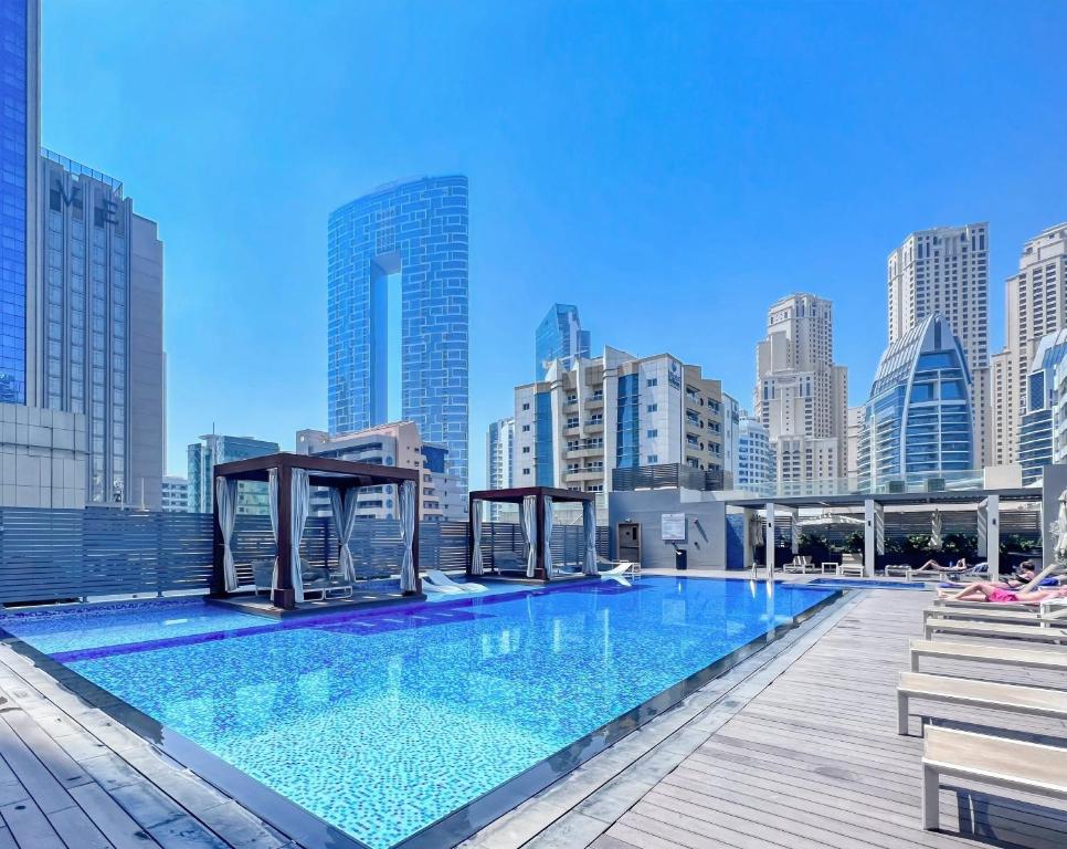 a large swimming pool on the roof of a building at Exquisite 1 BDR apt in the heart of Dubai Marina- Studio One Tower in Dubai