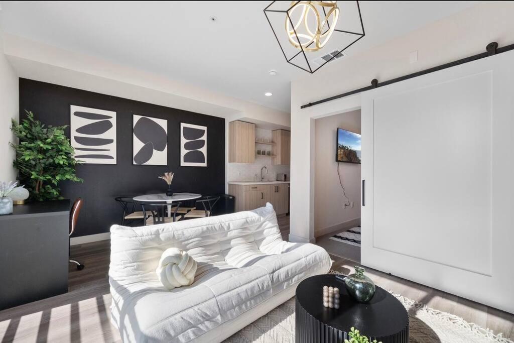 Una sala de estar con un sofá blanco y una mesa. en Irvine Luxury & Modern Home, en Santa Ana