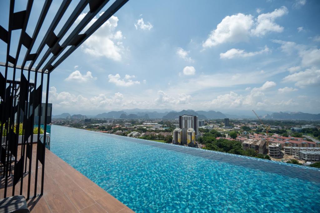 a infinity pool with a view of a city at Horizon Delux Suite @ Ipoh Town in Ipoh