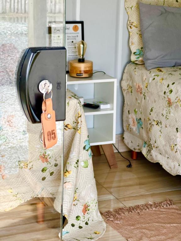 a room with a bed and a suitcase on the floor at Recanto Monte Trigo in São Francisco do Sul