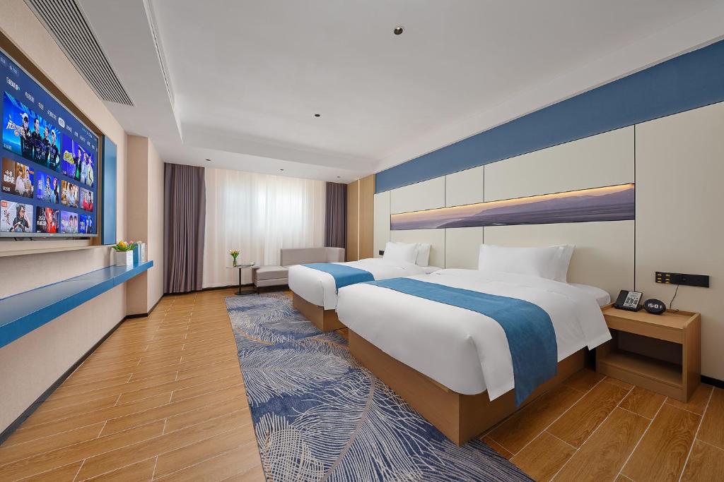 Postel nebo postele na pokoji v ubytování Pearl Hotel - Gongbei Port Zhuhai
