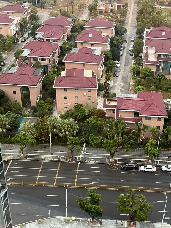 an aerial view of a parking lot with houses at Sha Zhi Ye Serviced Apartment Hotel - Houjie Wanda Plaza Liaoxia Subway Station in Dongguan