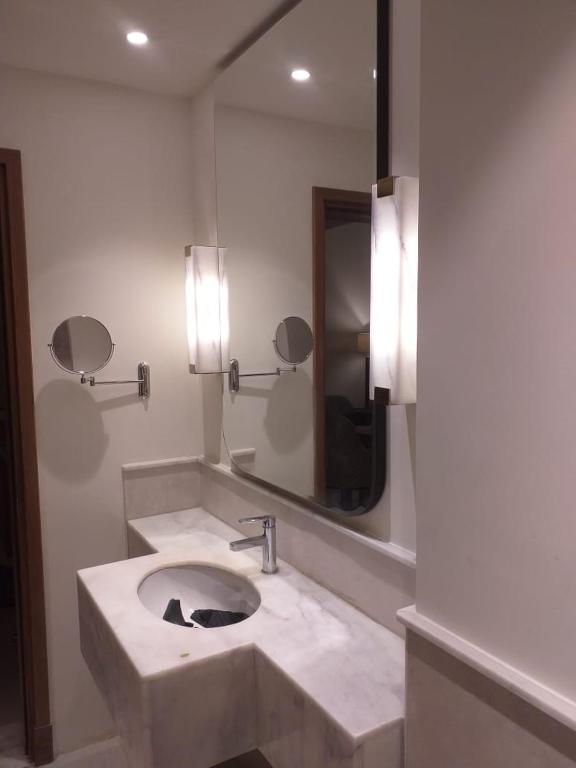 a bathroom with a sink and a mirror at Address marassi resort in El Alamein