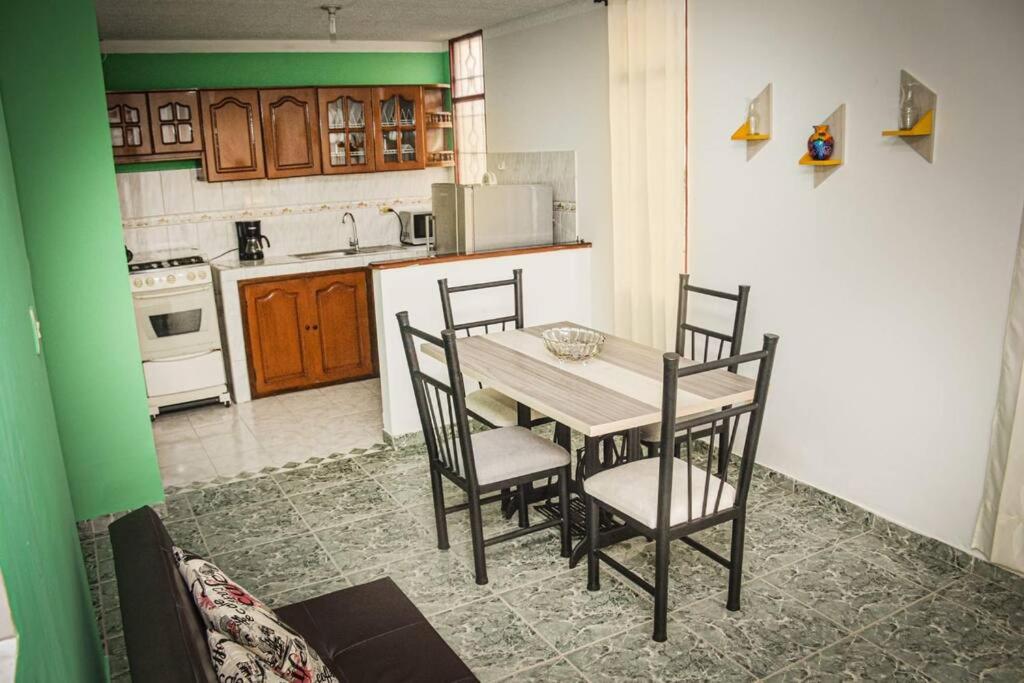 a kitchen with a table and chairs in a room at Casa amplia con garaje in Fusagasuga