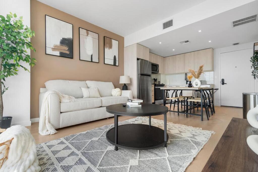 a living room with a white couch and a table at Wynwood Luxury Apt in Miami
