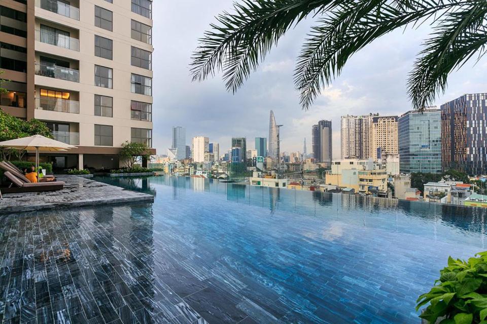 a infinity pool with a view of the city at Olala SaiGon Apartment - Millennium Tower in Ho Chi Minh City
