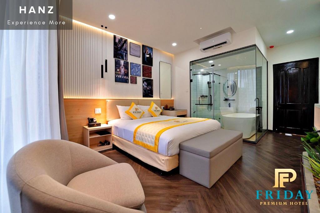 a bedroom with a bed and a chair and a bathroom at HANZ Premium Friday Hotel in Ho Chi Minh City