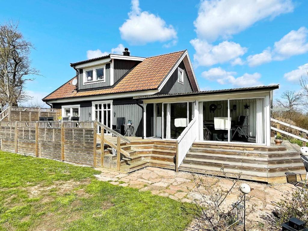 a home with a porch and a house at 4 star holiday home in FäRJESTADEN in Färjestaden