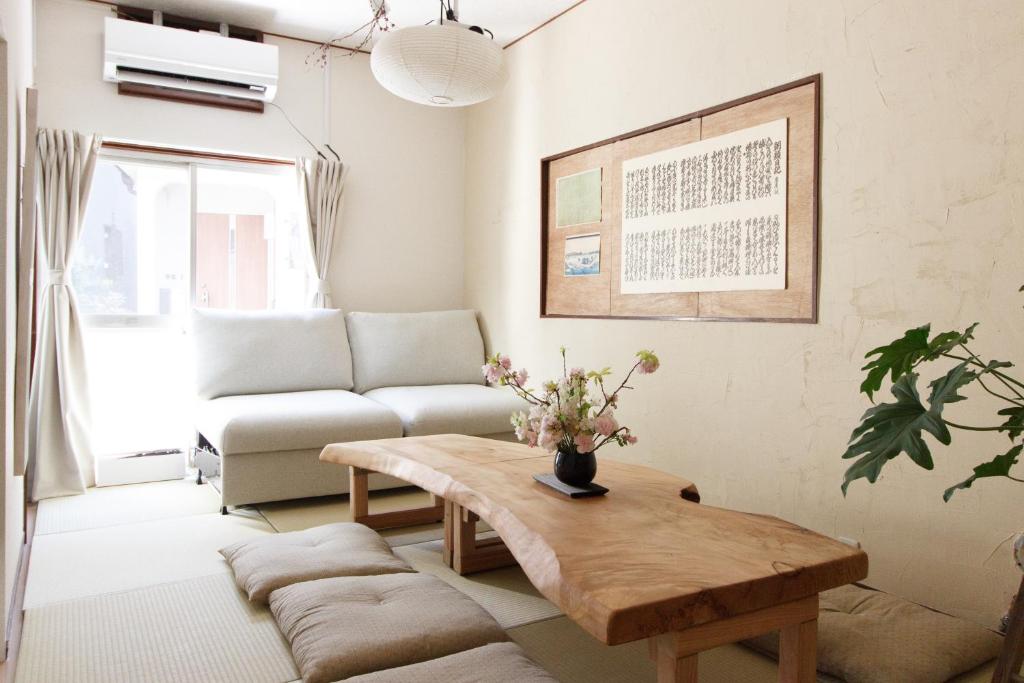 sala de estar con mesa de centro y sofá en Saku House Jujo, en Tokio