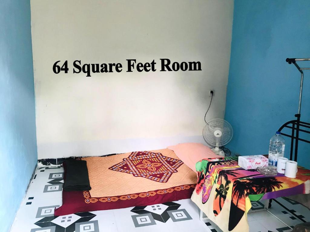 a bedroom with a bed with a four square feet room at Grand Mess in Comilla