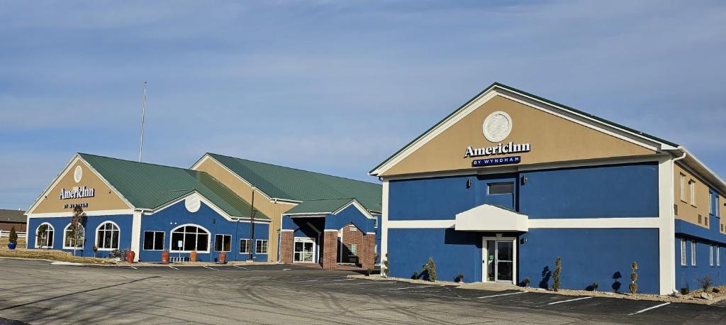 a large building with blue and white at AmericInn by Wyndham Grinnell in Grinnell