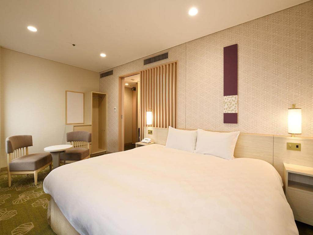 a large white bed in a hotel room at Shinjuku Prince Hotel in Tokyo