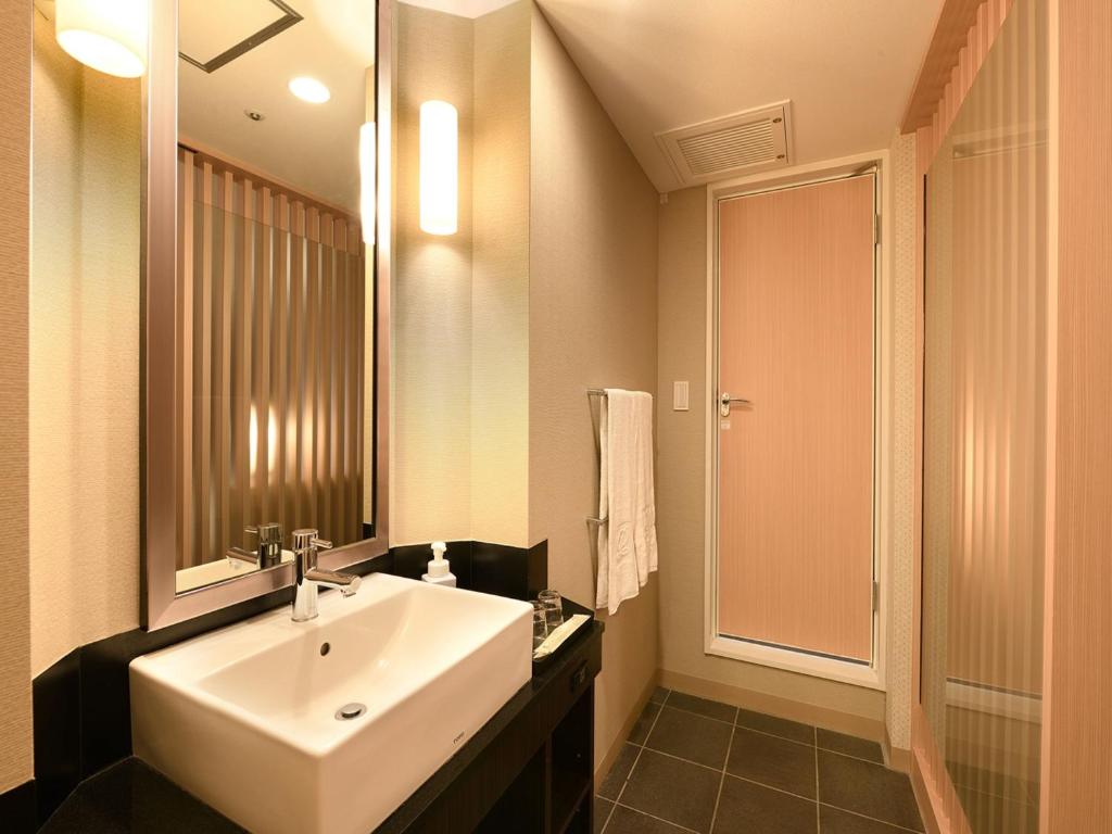 a bathroom with a white sink and a mirror at Shinjuku Prince Hotel in Tokyo