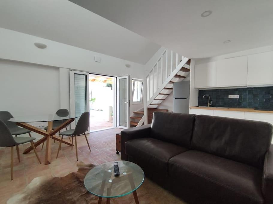 a living room with a couch and a glass table at 28 Casa do Avô - 2Km from the beach in Sesimbra