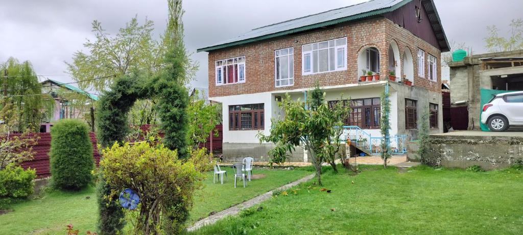 a house with a lawn in front of it at Elizabeth paying guest house Tangmarg gulmarg in Gulmarg