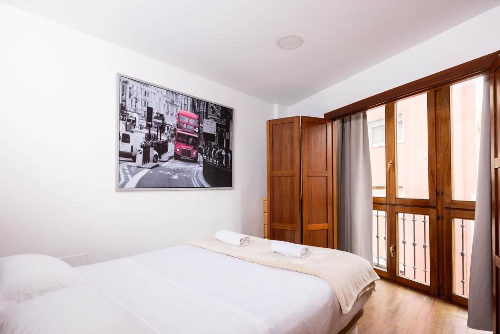 A bed or beds in a room at Apartamentos Turísticos Distrito Romano by CartagenaSpain