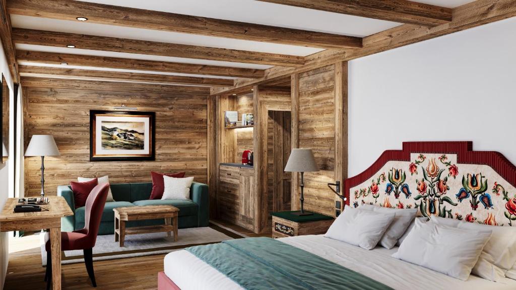 a hotel room with a bed and a couch at Hotel Tyrol in Selva di Val Gardena