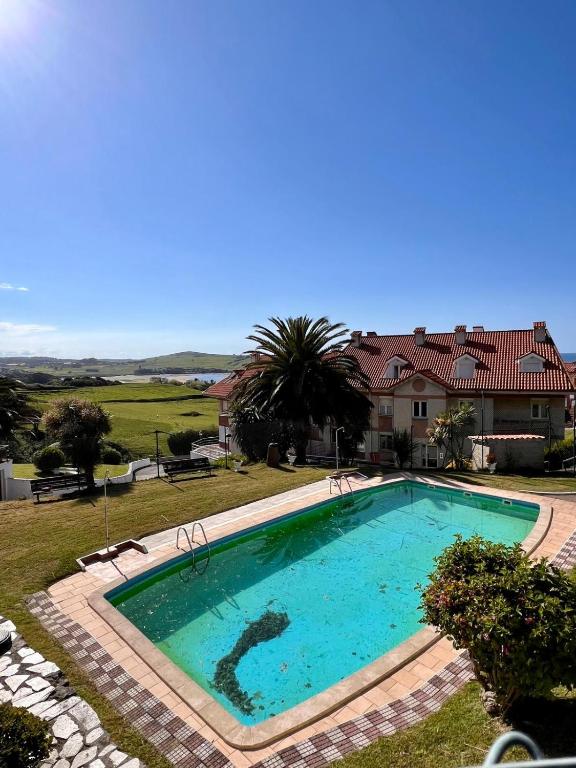 a large swimming pool in front of a house at Apartamento La Caleta III - Monabri in Mogro