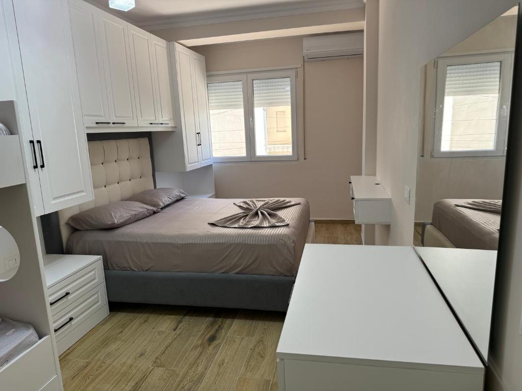 a small bedroom with a bed and white cabinets at GOLEM Best Apartment in Golem