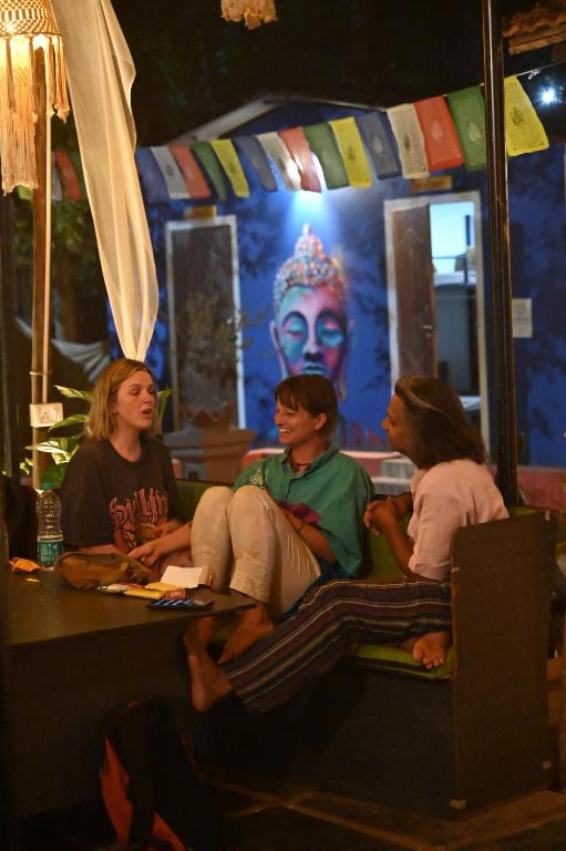 a group of women sitting on a table in a room at BunkNBrew in Palolem