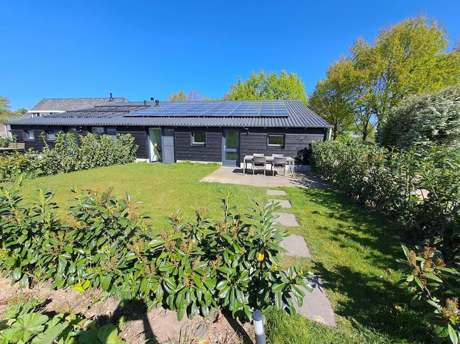 a house with solar panels on the roof at De Platwever 3C in Zelhem