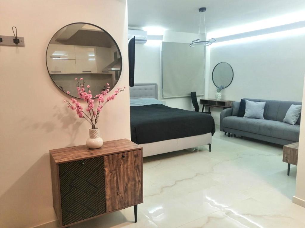 a bedroom with a bed and a mirror on the wall at BlackGeorge Apartment in Ioannina