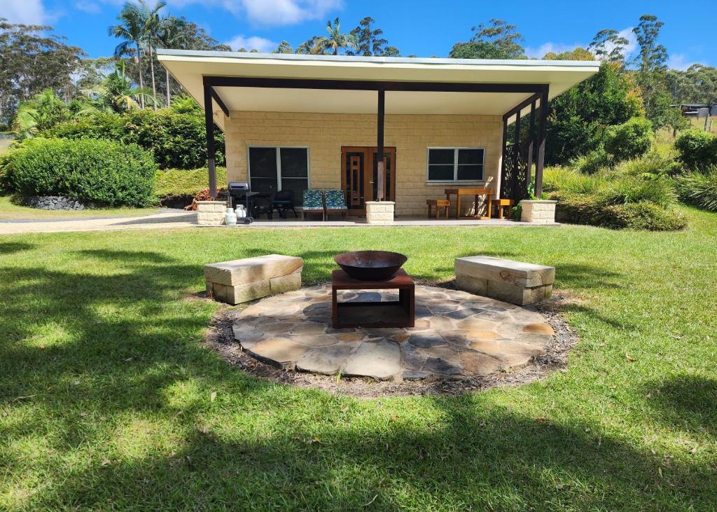 a backyard with a fire pit in the grass at Coffs Coast Mountain Retreat Cabin 2 in Coramba