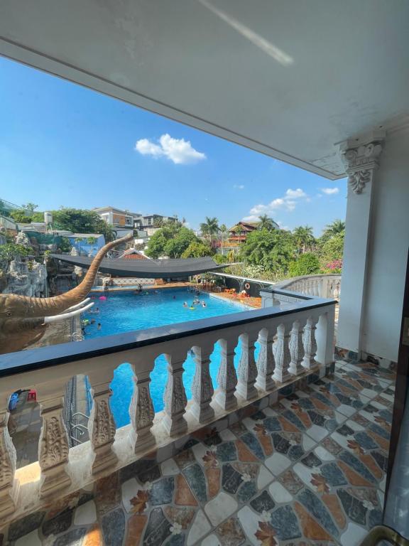 a balcony with a view of a pool at DNA Villa Space in Buôn Dhă Prŏng