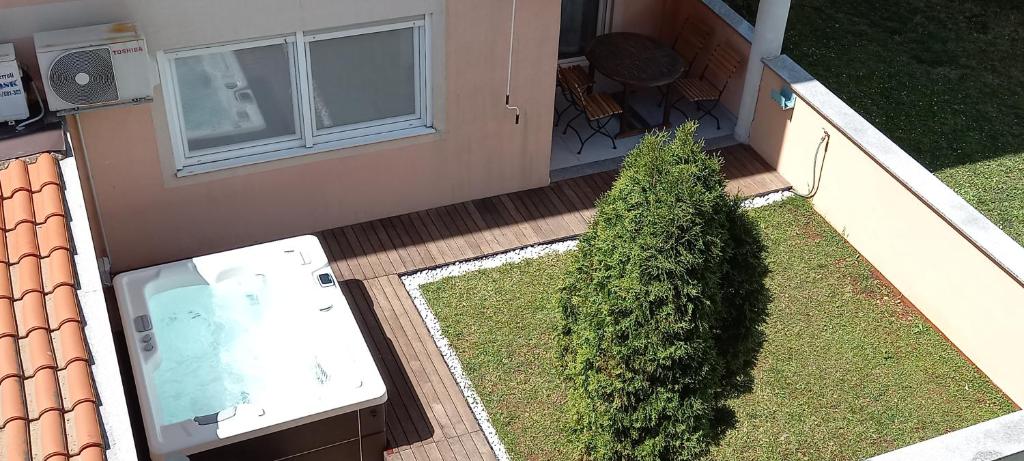 an aerial view of a porch with a bush next to a house at Apartment Onbria Mar in Medulin