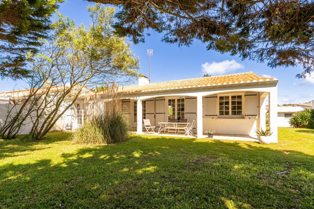 een wit huis met een tuin bij Villa de la mer - Bretignolles in Brétignolles-sur-Mer