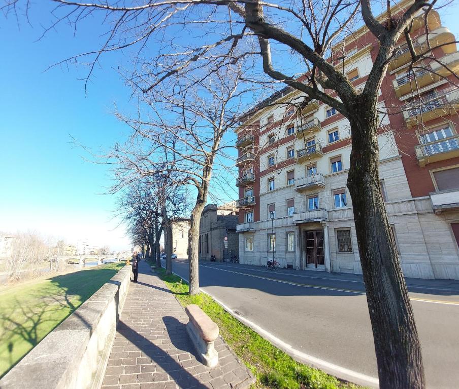 a bench on a sidewalk next to a building at Eveve's House in Parma